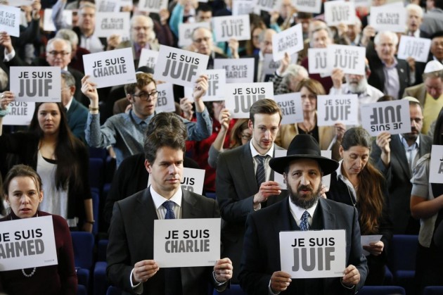Members of the Board of Deputies of British Jews hold up signs during an event in London