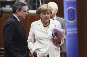 File phot of ECB President Draghi talking to Germany's Chancellor Merkel during European Union leaders summit in Brussels