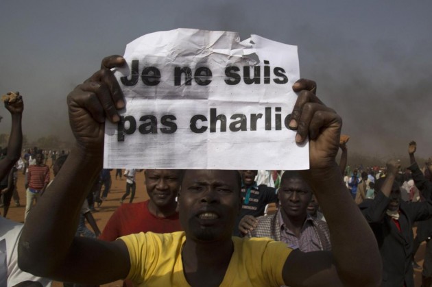 A man holds a sign during a protest against Niger President Issoufou's attendance last week at a Paris rally in support of French satirical weekly Charlie Hebdo, in Niamey