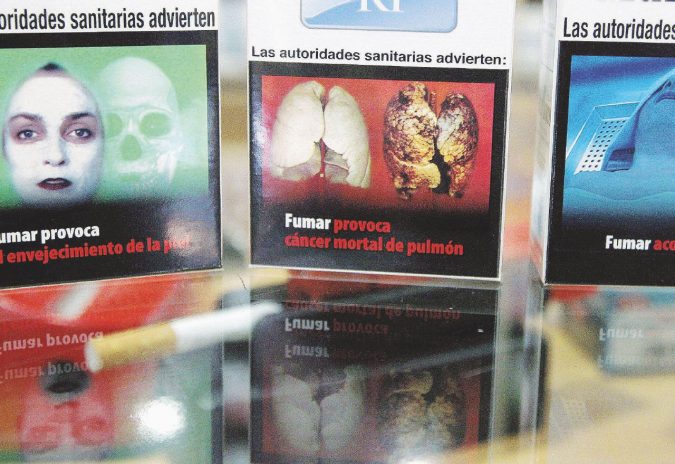 IMAGE SHOWS THREE PACKETS OF CIGARETTES WITH THE NEW IMAGES ABOUT THE TOBACCO'S CONSECUENCES IN THE HEALTH