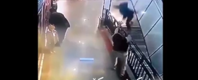 Copertina di Malesia, un uomo afferra al volo un bimbo che precipita dalle scale di un centro commerciale