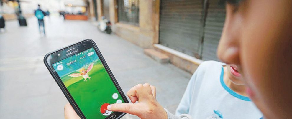 Connesso - Un ragazzino che gioca con la nuova applicazione Pokemon Go - LaPresse Caro figlio, ecco cinque regole per il tuo primo cellulare
