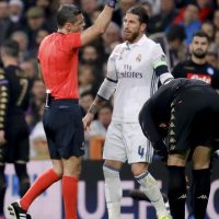 Slovenian referee Damir Skomina (L) gives a yellow card to Real Madrid’s defender Sergio Ramos during the UEFA Champions League round of 16 match between Real Madrid and Napoli at Santiago Bernabeu stadium in Madrid, Spain, 15 February 2017. EFE/JuanJo Martin