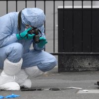 A forensics investigator photographs knives on the ground after man in Westminster after an arrest was made on Whitehall in central London, Britain, April 27, 2017. REUTERS/Toby Melville