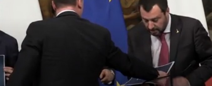 Copertina di Casalino dà a Salvini il cartello con la scritta “reddito di cittadinanza” e lui reagisce così: imbarazzo prima della foto