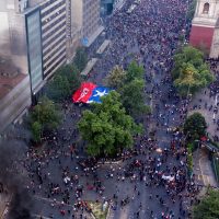 Aerial view of people demonstrating in Santiago, on October 25, 2019, a week after violence protests started. – Demonstrations against a hike in metro ticket prices in Chile’s capital exploded into violence on October 18, unleashing widening protests over living costs and social inequality. (Photo by PABLO COZZAGLIO / AFP)