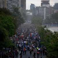 Aerial view of people demonstrating in Santiago, on October 25, 2019, a week after violence protests started. – Demonstrations against a hike in metro ticket prices in Chile’s capital exploded into violence on October 18, unleashing widening protests over living costs and social inequality. (Photo by Pablo VERA / AFP)