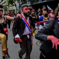 Disguised demonstrators take part in a protest in Santiago, on October 25, 2019, a week after violent protests started. – Demonstrations against a hike in metro ticket prices in Chile’s capital exploded into violence on October 18, unleashing widening protests over living costs and social inequality. (Photo by MARTIN BERNETTI / AFP)