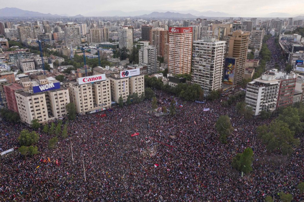 In this aerial view thousands of people protest in Santiago, on October 25, 2019, a week after violent protests started. – Demonstrations against a hike in metro ticket prices in Chile’s capital exploded into violence on October 18, unleashing widening protests over living costs and social inequality. (Photo by Pedro Ugarte / AFP)