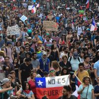 People demonstrate in Santiago, on October 25, 2019, a week after violence protests started. – Demonstrations against a hike in metro ticket prices in Chile’s capital exploded into violence on October 18, unleashing widening protests over living costs and social inequality. (Photo by Martin BERNETTI / AFP)