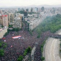 In this aerial view thousands of people protest in Santiago, on October 25, 2019, a week after violence protests started. – Demonstrations against a hike in metro ticket prices in Chile’s capital exploded into violence on October 18, unleashing widening protests over living costs and social inequality. (Photo by PEDRO UGARTE / AFP)