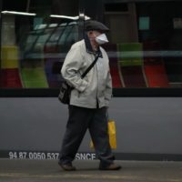 A man wearing a face mask walks on the platform at the Saint Lazare train station Monday, May 11, 2020 in Paris. France is begin to reopen Monday after two months of virus confinement measures. Shops, hair salons and some other businesses are reopening Monday and French citizens no longer need a special permission form to leave the house. (AP Photo/Francois Mori)