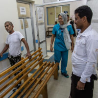 Yemen, Hodeidah, Al Salakhana hospital, 30 April 2019 – Yasser (caretaker, right) and Ahmed (left), are both fishermen from Khawkha, south of Hodeidah: Ahmed was injured while fishing on his boat three months ago. According to him, it was a missile or an airstrike, and several fishermen were injured on his boat. Ahmed has external fixators on his left leg.