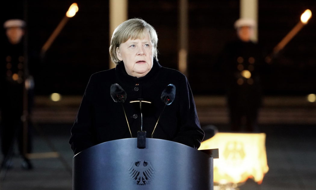epa09617253 German Chancellor Angela Merkel speaks during the military grand tattoo in her honor at the defense ministry in Berlin, Germany, 02 December 2021. Acting German Chancellor Angela Merkel receives on 02 December 2021, on the occasion of her farewell, a Grand Tattoo of the German Federal Armed Forces (Bundeswehr).  EPA/FRIEDEMANN VOGEL