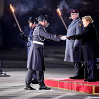 epa09617260 German Chancellor Angela Merkel (R) during the military grand tattoo in her honor at the defense ministry in Berlin, Germany, 02 December 2021. Acting German Chancellor Angela Merkel receives on 02 December 2021, on the occasion of her farewell, a Grand Tattoo of the German Federal Armed Forces (Bundeswehr).  EPA/FRIEDEMANN VOGEL
