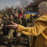 Larisa Borisenkov sings for Ukrainian servicemen with the 34th Battalion near the frontline village of Krymske, Luhansk region, in eastern Ukraine, Saturday, Feb. 19, 2022. Ukrainian President Volodymyr Zelenskyy, facing a sharp spike in violence in and around territory held by Russia-backed rebels and increasingly dire warnings that Russia plans to invade, on Saturday called for Russian President Vladimir Putin to meet him and seek resolution to the crisis. (AP Photo/Vadim Ghirda)