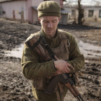 A Ukrainian serviceman walks near the frontline village of Krymske, Luhansk region, in eastern Ukraine, Saturday, Feb. 19, 2022. Ukrainian President Volodymyr Zelenskyy, facing a sharp spike in violence in and around territory held by Russia-backed rebels and increasingly dire warnings that Russia plans to invade, on Saturday called for Russian President Vladimir Putin to meet him and seek resolution to the crisis. (AP Photo/Vadim Ghirda)