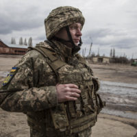 A Ukrainian soldiers stands in the village of Novoluhanske, Luhansk region, Ukraine, Saturday, Feb. 19, 2022. Separatist leaders in eastern Ukraine have ordered a full military mobilization amid growing fears in the West that Russia is planning to invade the neighboring country. The announcement on Saturday came amid a spike in violence along the line of contact between Ukrainian forces and the pro-Russia rebels in recent days. (AP Photo/Oleksandr Ratushniak)