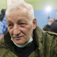 A man waits to be registered at a recruiting station in Donetsk, the territory controlled by pro-Russian militants, eastern Ukraine, Saturday, Feb. 19, 2022. A separatist leader in eastern Ukraine has ordered full military mobilization amid growing invasion fears. (AP Photo/Alexei Alexandrov)