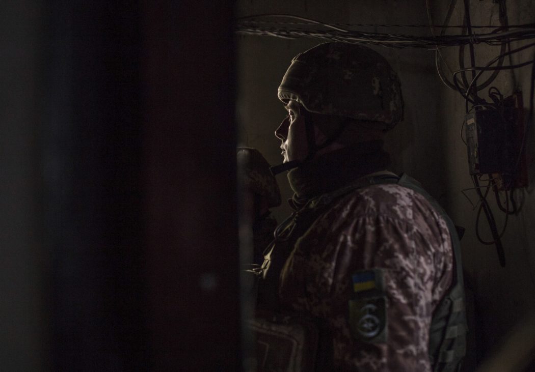 Ukrainian soldiers hide in a shelter during shelling by pro-Russian separatists in the village of Novoluhanske, Luhansk region, Ukraine, Saturday, Feb. 19, 2022. Separatist leaders in eastern Ukraine have ordered a full military mobilization amid growing fears in the West that Russia is planning to invade the neighboring country. The announcement on Saturday came amid a spike in violence along the line of contact between Ukrainian forces and the pro-Russia rebels in recent days. (AP Photo/Oleksandr Ratushniak)