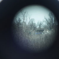 The gray area is visible through the periscope on a Ukrainian Army position at the line of separation between Ukraine-held territory and rebel-held territory near Zolote, Ukraine, late Saturday, Feb. 19, 2022. Ukrainian President Volodymyr Zelenskyy, facing a sharp spike in violence in and around territory held by Russia-backed rebels and increasingly dire warnings that Russia plans to invade, has called for Russian President Vladimir Putin to meet him and seek a resolution to the crisis. (AP Photo/Evgeniy Maloletka)