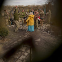 Larisa Borisenko sings for Ukrainian servicemen with the 34th Battalion near the frontline village of Krymske, Luhansk region, in eastern Ukraine, Saturday, Feb. 19, 2022. Ukrainian President Volodymyr Zelenskyy, facing a sharp spike in violence in and around territory held by Russia-backed rebels and increasingly dire warnings that Russia plans to invade, on Saturday called for Russian President Vladimir Putin to meet him and seek resolution to the crisis. (AP Photo/Vadim Ghirda)