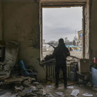 epaselect epa09794048 A member of the Territorial Defense Forces of Ukraine stands inside the damaged Kharkiv regional administration building in the aftermath of a shelling in downtown Kharkiv, Ukraine, 01 March 2022. Russian troops entered Ukraine on 24 February prompting the country’s president to declare martial law and triggering a series of announcements by Western countries to impose severe economic sanctions on Russia.  EPA/SERGEY KOZLOV