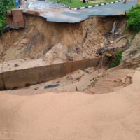 A damaged road in north coast of Durban, South Africa, Tuesday, April 12, 2022. Prolonged rains and flooding in South Africa’s KwaZulu-Natal province have claimed dozens of lives, according to local officials. (AP Photo/Eileen Anderson)