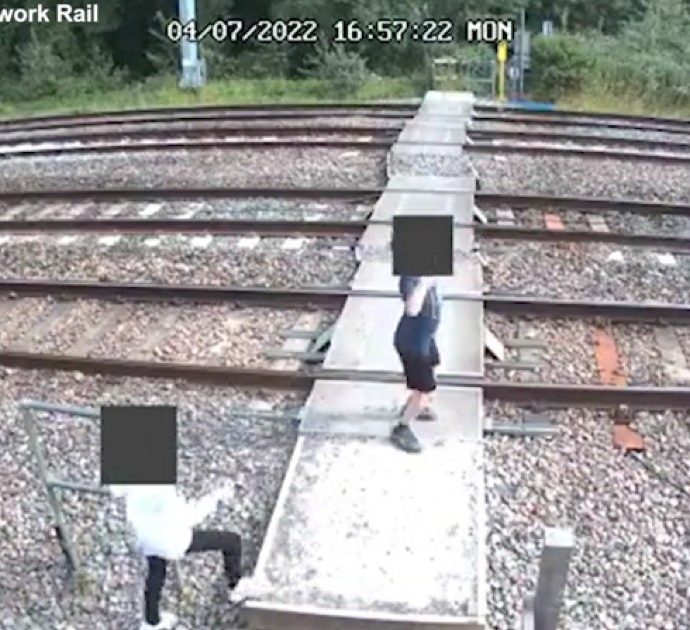 Bambini ballano e giocano sui binari della ferrovia mentre passa il treno: le immagini riprese dalle telecamere di sicurezza