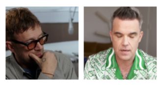 Copertina di Robbie Williams scatenato contro Damon Albarn: “Penso che dicendo queste cose stia masturbandosi”. Ecco cosa è accaduto