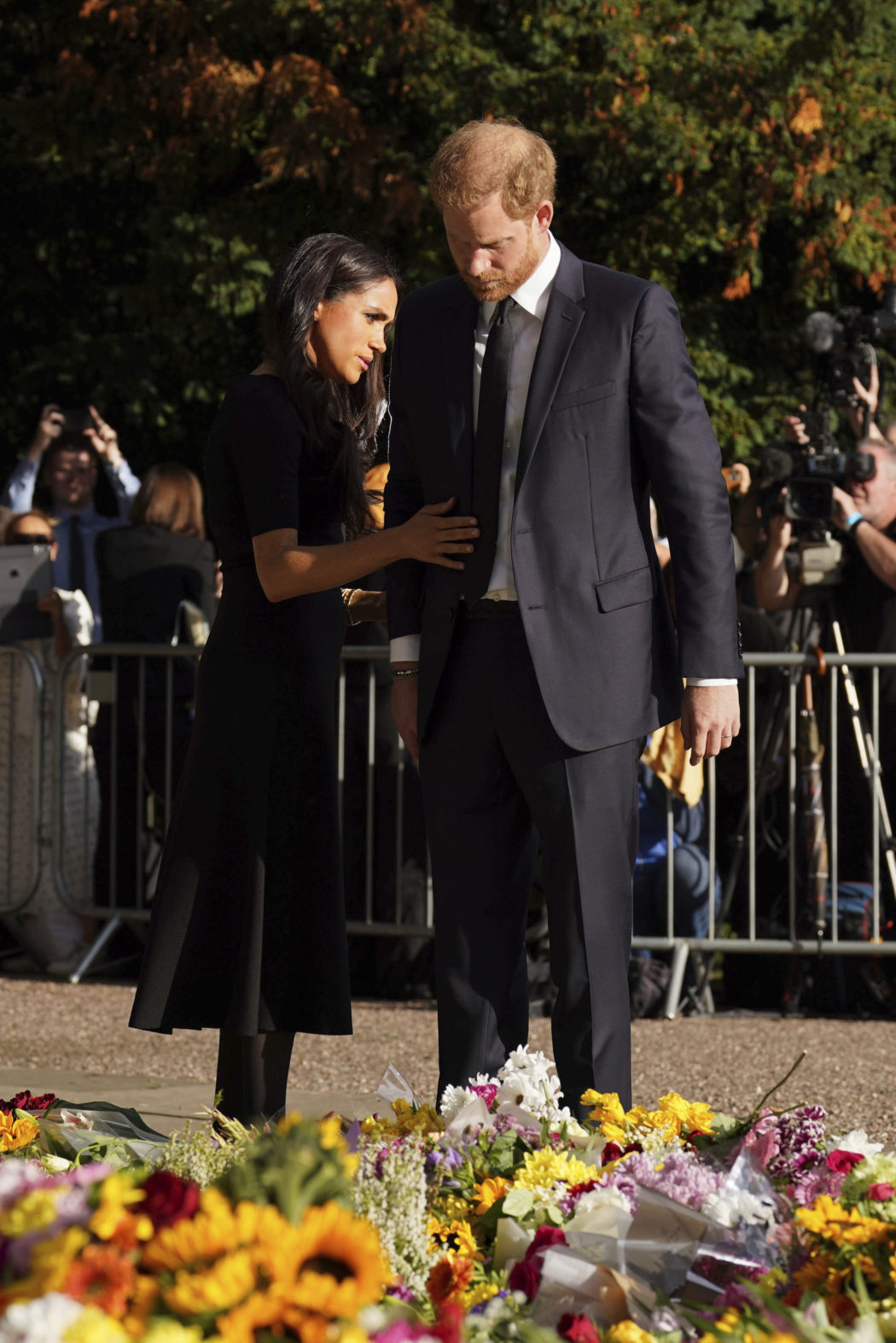 Meghan, Duchess of Sussex and Prince Harry look at floral tributes as they meet members of the public at Windsor Castle, following the death of Queen Elizabeth II on Thursday, in Windsor, England, Saturday, Sept. 10, 2022. (Kirsty O’Connor/Pool Photo via AP)