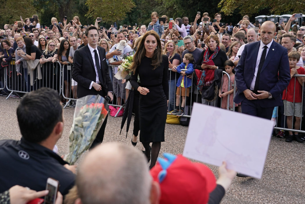 Kate, Princess of Wales greets the crowds after viewing the floral tributes for the late Queen Elizabeth II outside Windsor Castle, in Windsor, England, Saturday, Sept. 10, 2022. (AP Photo/Alberto Pezzali)