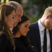 Britain’s Prince William and Kate, Princess of Wales, left, and Britain’s Prince Harry and Meghan, Duchess of Sussex view the floral tributes for the late Queen Elizabeth II outside Windsor Castle, in Windsor, England, Saturday, Sept. 10, 2022. (AP Photo/Alberto Pezzali)