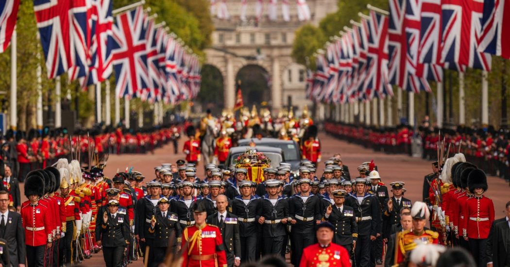 The coffin of Queen Elizabeth II is pulled past Buckingham Palace following her funeral service in Westminster Abbey in central London, Monday, Sept. 19, 2022. The Queen, who died aged 96 on Sept. 8, will be buried at Windsor alongside her late husband, Prince Philip, who died last year. (AP Photo/Vadim Ghirda, Pool)