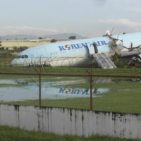 A damaged Korean Air plane sits after it overshot the runway at the Mactan-Cebu International Airport in Cebu, central Philippines early Monday Oct. 24, 2022. The Korean Air plane overshot the runway while landing in bad weather in the central Philippines late Sunday, but authorities said all 173 people on board were safe. (AP Photo/Juan Carlo De Vela)