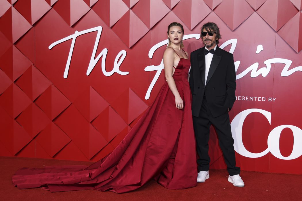 Florence Pugh, left, and Pier Paolo Piccioli pose for photographers upon arrival at the British Fashion Awards in London, Monday, Dec. 5, 2022. (Photo by Vianney Le Caer/Invision/AP)