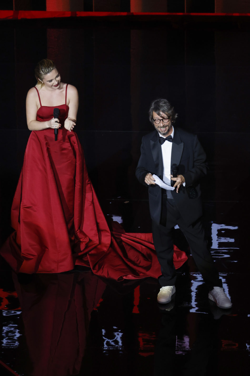 LONDON, ENGLAND – DECEMBER 05: Florence Pugh presents the Designer Of The Year award to Pierpaolo Piccioli for Valentino on stage during The Fashion Awards 2022 at the Royal Albert Hall on December 05, 2022 in London, England. (Photo by John Phillips/BFC/Getty Images for BFC)
