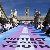 Demonstrators unroll a banner on the steps of the Campidoglio during the Trans Day of Visibility, Rome, Italy, 1 April 2023. ANSA/RICCARDO ANTIMIANI