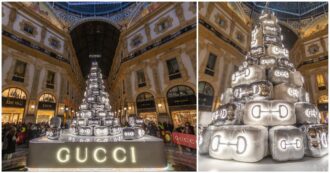 Copertina di L’albero di Natale di Gucci in Galleria Vittorio Emanuele a Milano fa discutere: “Una discarica di valigie”, “una catasta di cuscini” – VIDEO