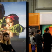People attend the exhibition with the winning photos 