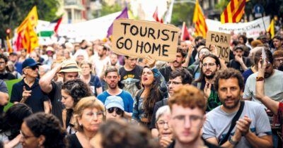 Copertina di Pistole ad acqua contro i turisti a Barcellona. Manifestanti: “Spegniamo l’incendio turistico”
