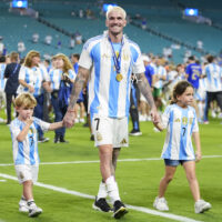 Argentina’s Rodrigo De Paul holds hands with his son Bautista and his daughter Francesca after his team defeated Colombia in the Copa America final soccer match in Miami Gardens, Fla., Monday, July 15, 2024. (AP Photo/Rebecca Blackwell)