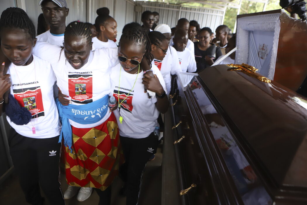 Relatives try to comfort a woman crying after viewing the body of Ugandan Olympic athlete Rebecca Cheptegei at Moi Teaching and Referral Hospital morgue in the western city of Eldoret, in Rift Valley, Kenya Friday, Sept. 13, 2024. (AP Photo/Andrew Kasuku)