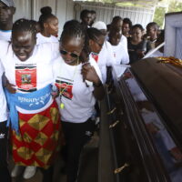 Relatives try to comfort a woman crying after viewing the body of Ugandan Olympic athlete Rebecca Cheptegei at Moi Teaching and Referral Hospital morgue in the western city of Eldoret, in Rift Valley, Kenya Friday, Sept. 13, 2024. (AP Photo/Andrew Kasuku)