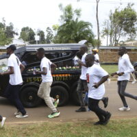 Members of the public escort a hearse carrying the coffin of Ugandan Olympic athlete Rebecca Cheptegei in the western city of Eldoret, in Rift Valley, Kenya Friday, Sept. 13, 2024. (AP Photo/Andrew Kasuku)