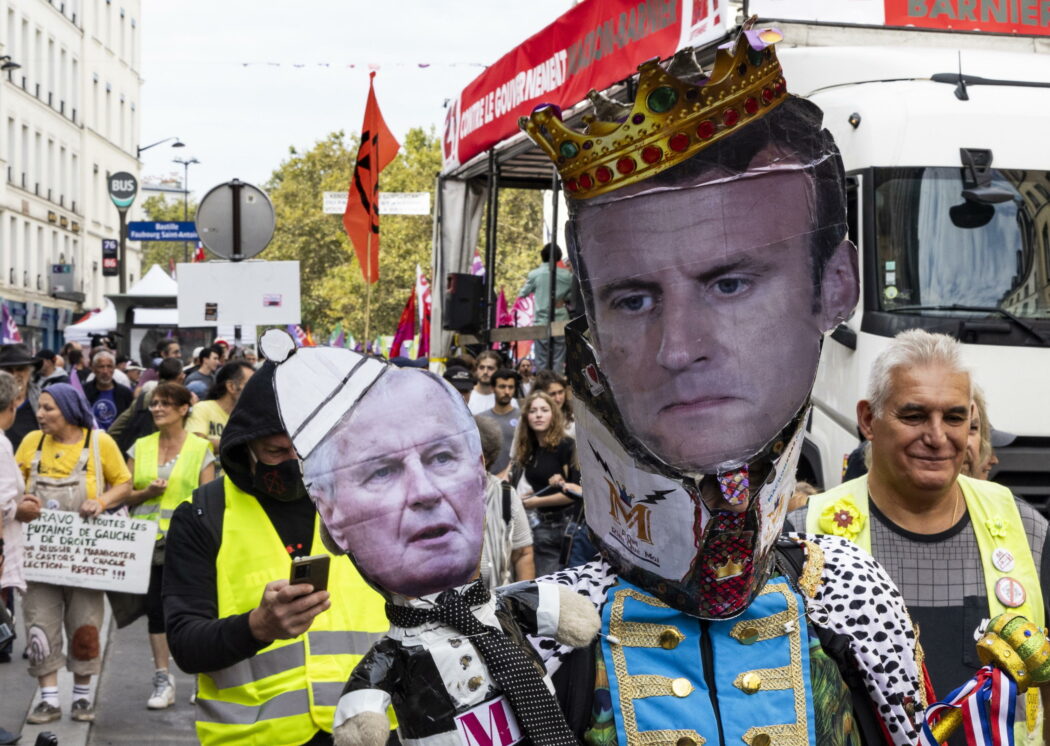 epa11617512 Protesters hold an placard of  the Prime Minister Michel Barnier and French President Emmanuel Macron during a protest, in Paris, France, 21 September 2024. Newly appointed French Prime Minister Michel Barnier communicated the list of names of his proposed government to the French President Emmanuel Macron on 20 September. The approval of this list is expected to be in the next few days. The French left parties coalition, Nouveau Front Populaire (NFP), which had arrived ahead in the last legislative elections but fell short of a full majority, called for rallies on 21 September, as they say that their win was not taken in consideration in the formation of the new cabinet.  EPA/ANDRE PAIN