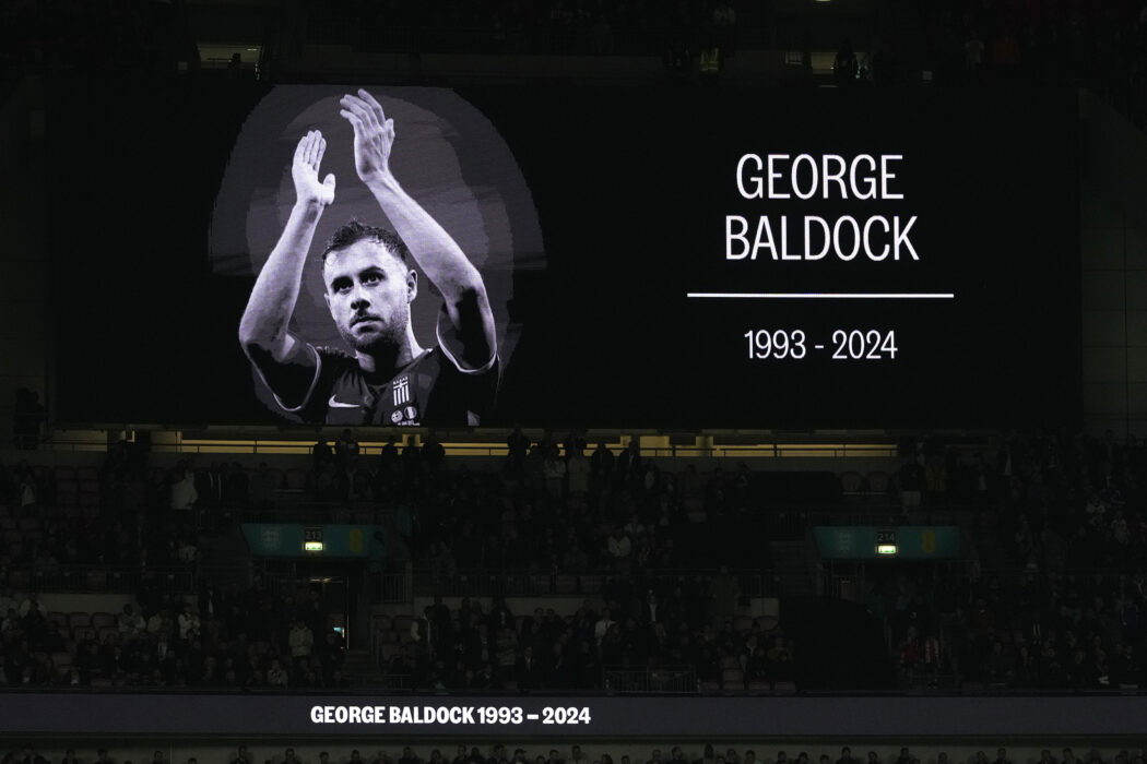 A portrait of George Baldock is shown on the screen before the UEFA Nations League Group F soccer match between England and Greece at Wembley Stadium in London, Thursday, Oct. 10, 2024. England-born Greece international and Panathinaikos defender George Baldock, who had previously played for Sheffield United, has been found dead in his Athens home on Wednesday. (AP Photo/Kirsty Wigglesworth)

Associated Press/LaPresse