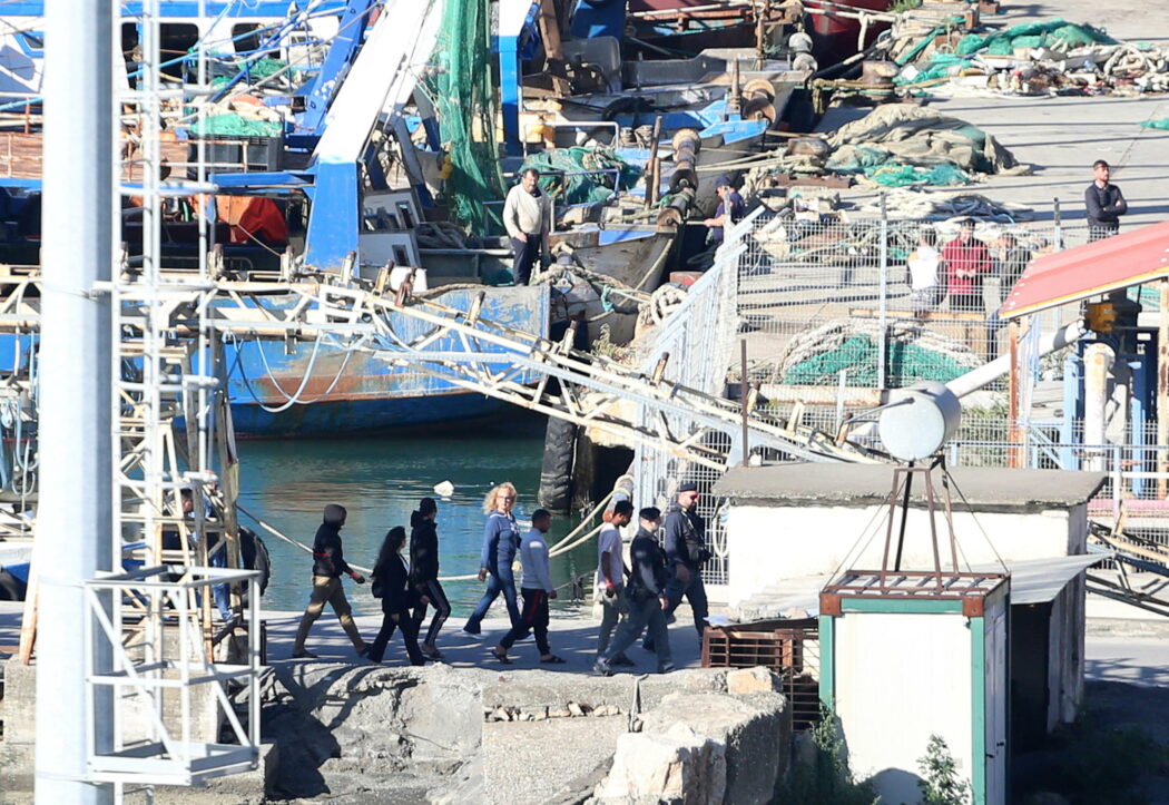 epa11661889 A group of migrants intercepted in Italian waters arrive aboard an Italian navy boat at Shengjin, Albania, 16 October 2024. Italy has begun sending migrants rescued in the Mediterranean to detention centers in Albania, where their asylum claims will be processed. The plan, finalized in February 2024, allows Italy to transfer up to 36,000 asylum seekers to Albania annually, with the goal of deterring migrants from attempting to reach Italy. While the Italian government and some EU leaders support the program, human rights groups criticize it for potentially putting migrants at risk and exposing them to rights violations.  EPA/MALTON DIBRA