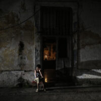 A resident sits while passing time during a blackout following the failure of a major power plant in Havana, Cuba, Saturday, Oct. 19, 2024. (AP Photo/Ramon Espinosa)
Associated Press/LaPresse