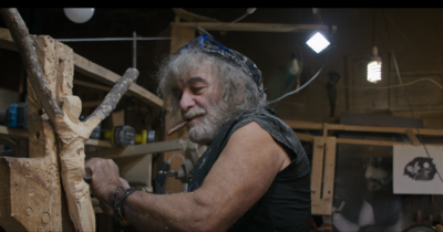 Copertina di “Faccio cose per non spararmi. La vecchiaia ha un vantaggio: non mi piacciono più i film porno”: Mauro Corona si confessa in un documentario